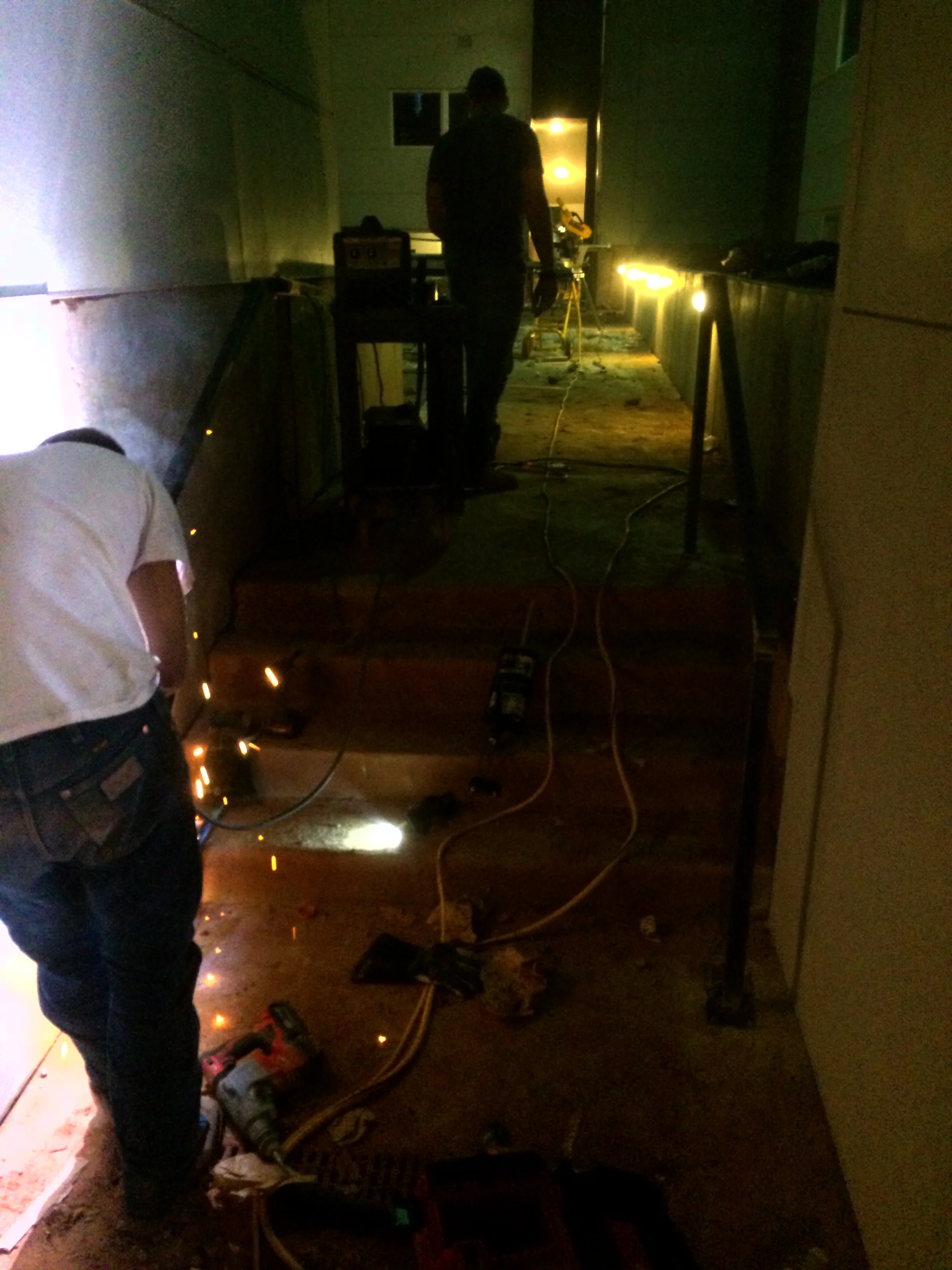 Alleyway electrical installation with recessed lighting fixtures and wiring during construction