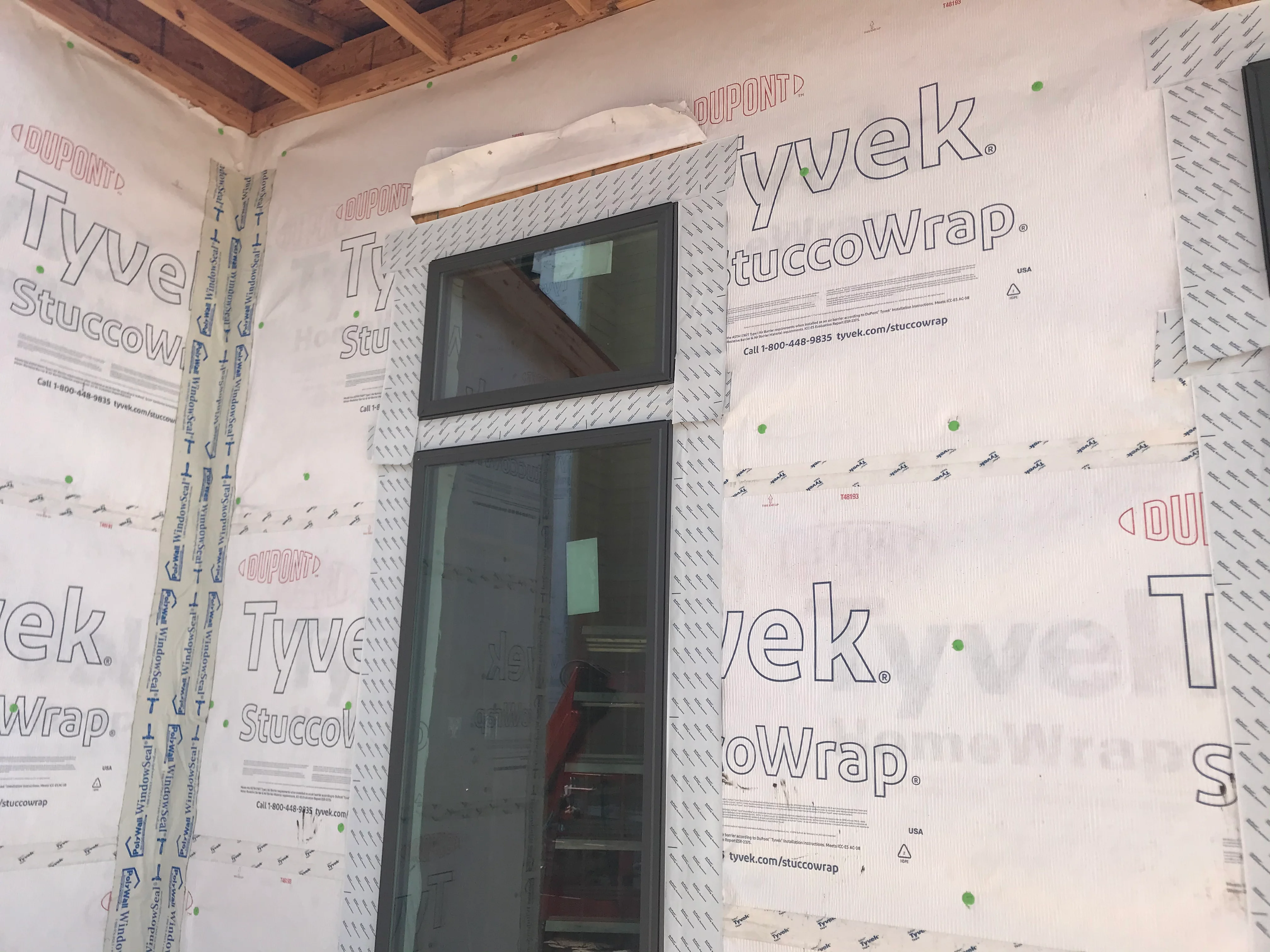 Interior wall with Tyvek StuccoWrap moisture barrier installed around window opening